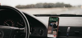 Dashboard of a car with phone being used as a navigation system